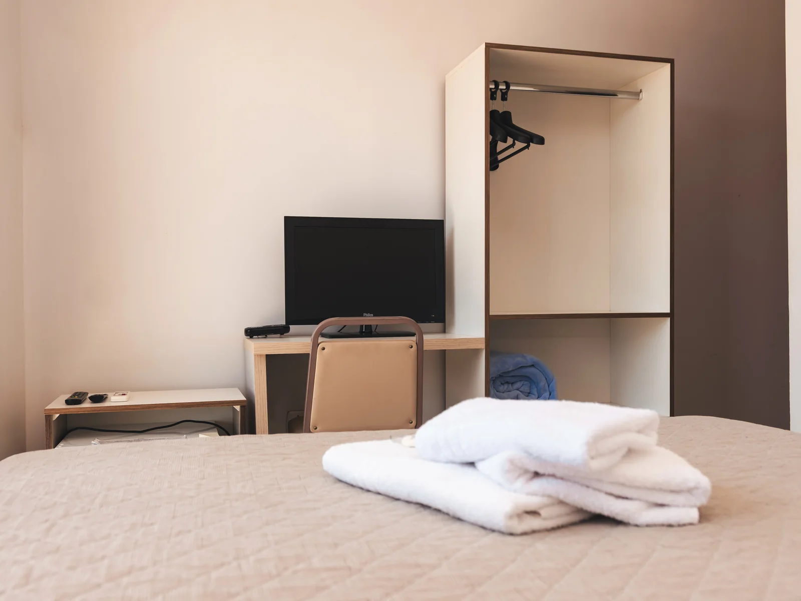 Armário, TV e espaço de trabalho em Apartamento Econômico do Sítio Hotel & Eventos